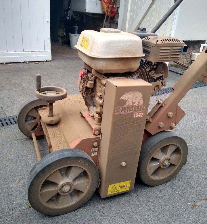 This image is of a very dusty scarifier following a lawn renovation | Lawn renovators