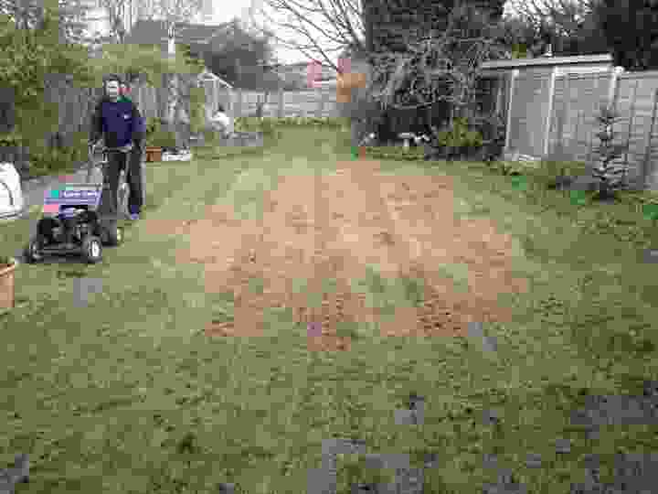 This image is of us at work with one of our lawn experts behind an aerator mid lawn renovation