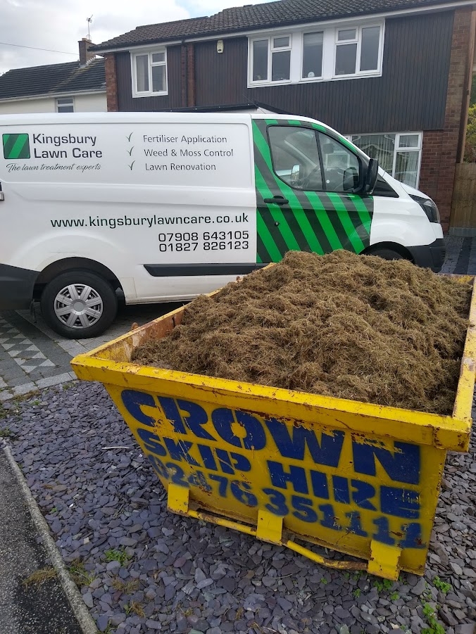 This image is with the lawn renovation completed with a skip full of moss and thatch removed