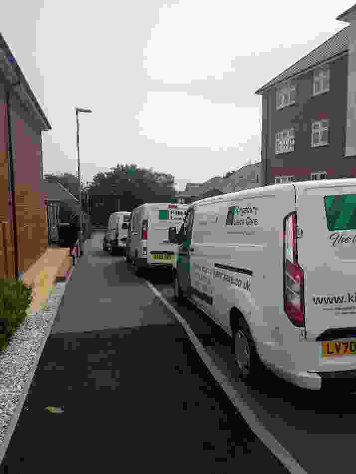 A number of lawn treatment service vans 