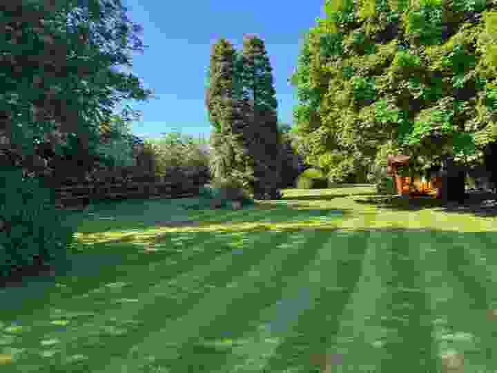 A large striped lawn benefiting from lawn treatment services | Kingsbury Lawn Care
