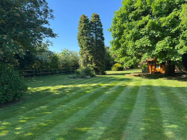 A large striped lawn benefiting from lawn treatment services | Kingsbury Lawn Care