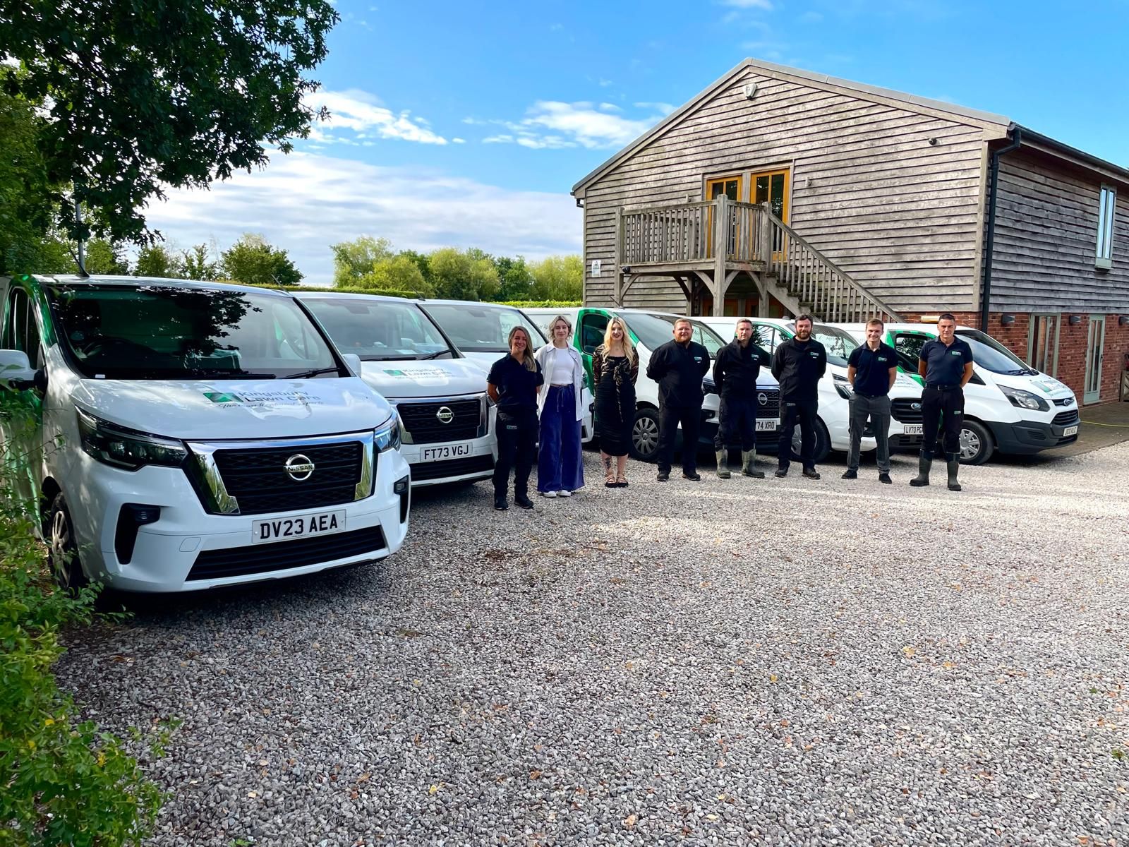The Kingsbury Lawn Care team with their branded service vans